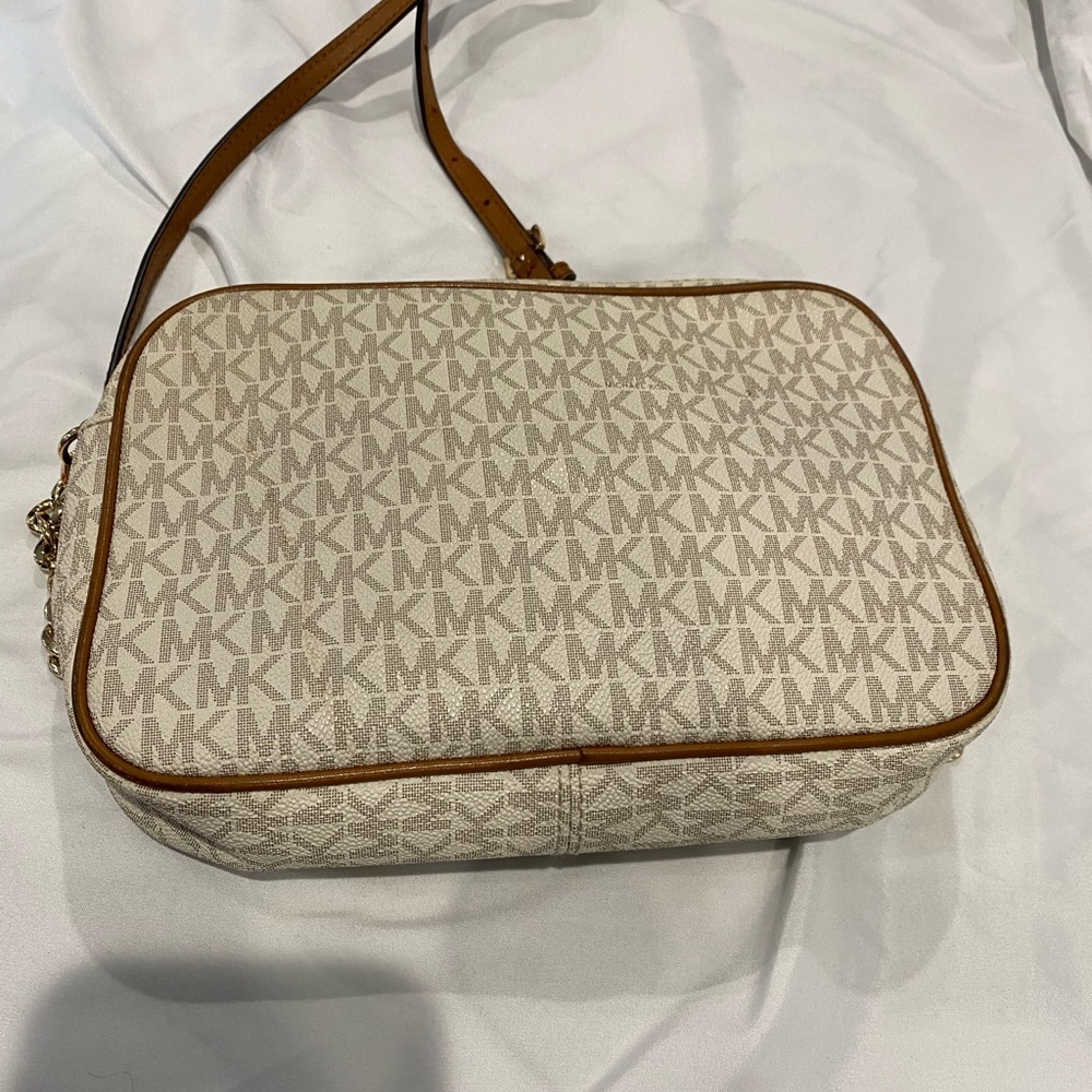 Michael Kors crossbody bag with initials MK all over it good condition